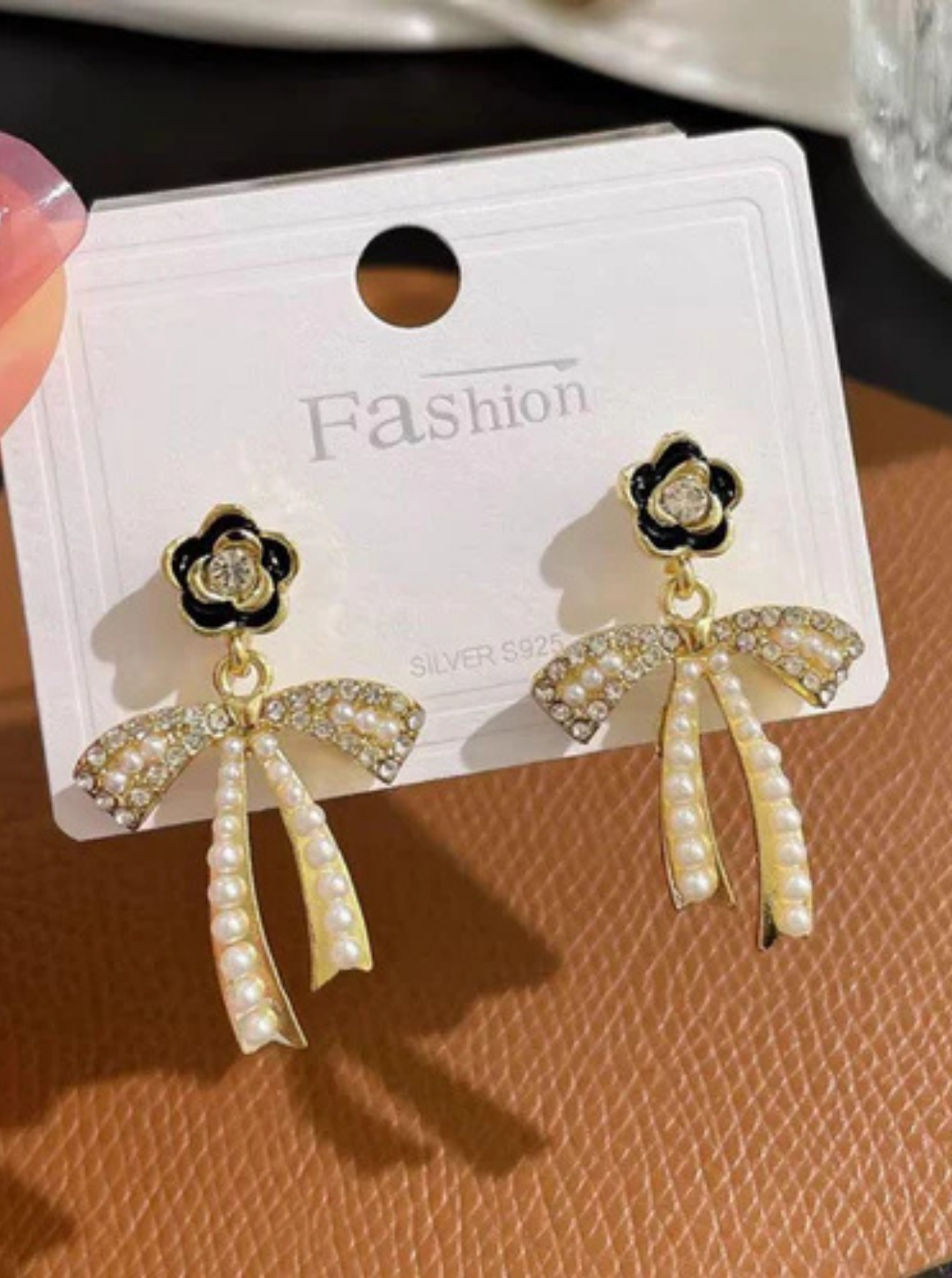 Rhinestone bow drop earrings with pearl beads
