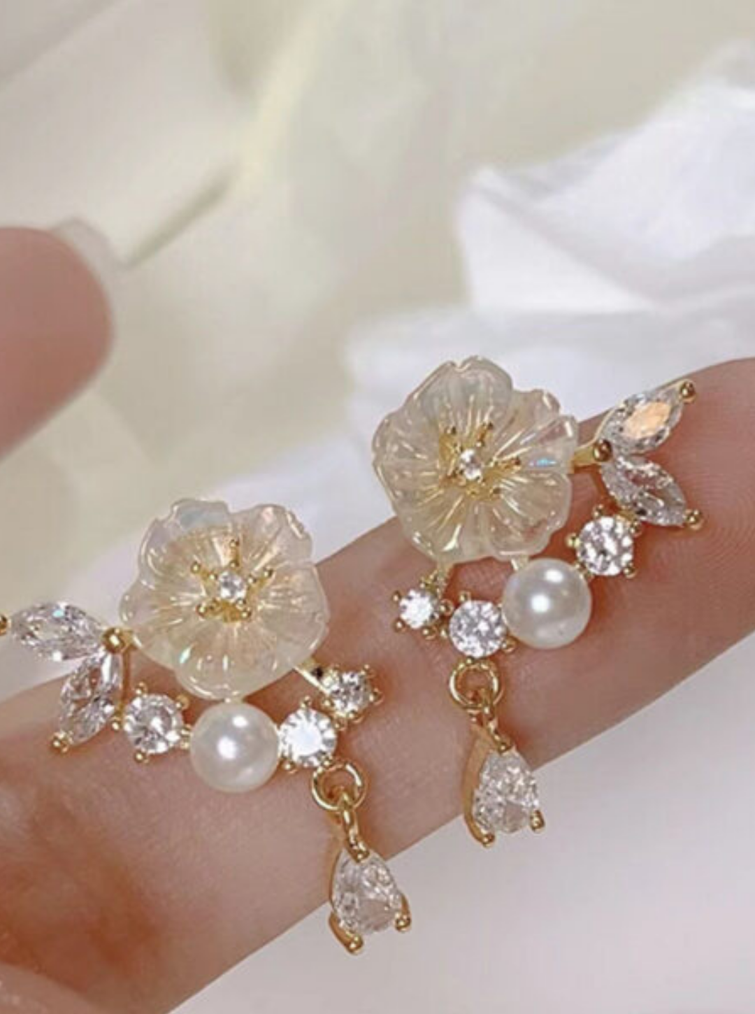 Petal crystal pearl drop earrings with floral design