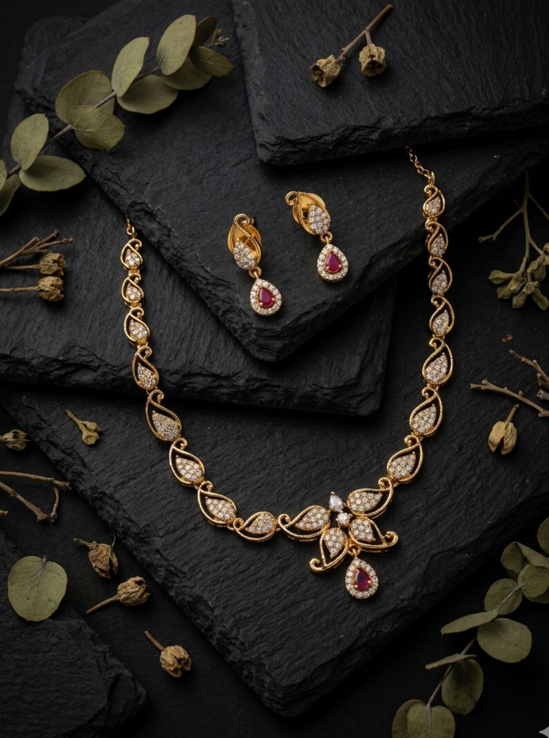 Gold necklace with leaf design and matching earrings
