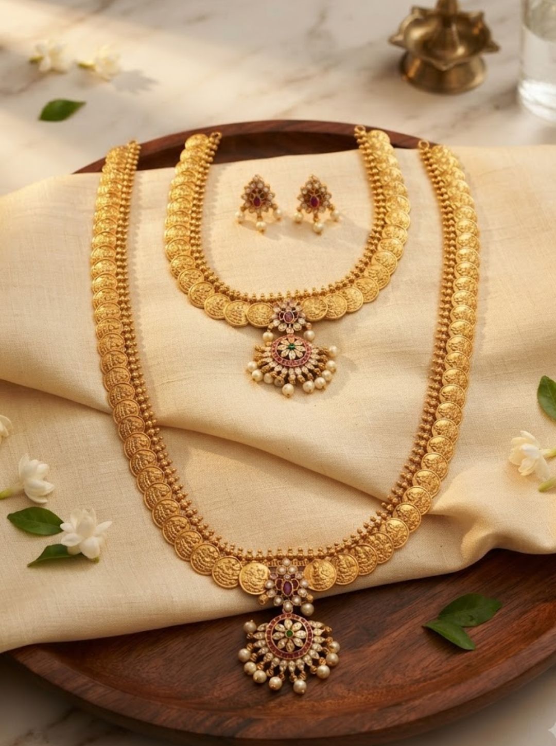 Classic traditional necklace set with gold-toned coin motifs, gemstone accents and pearl-like drops.
