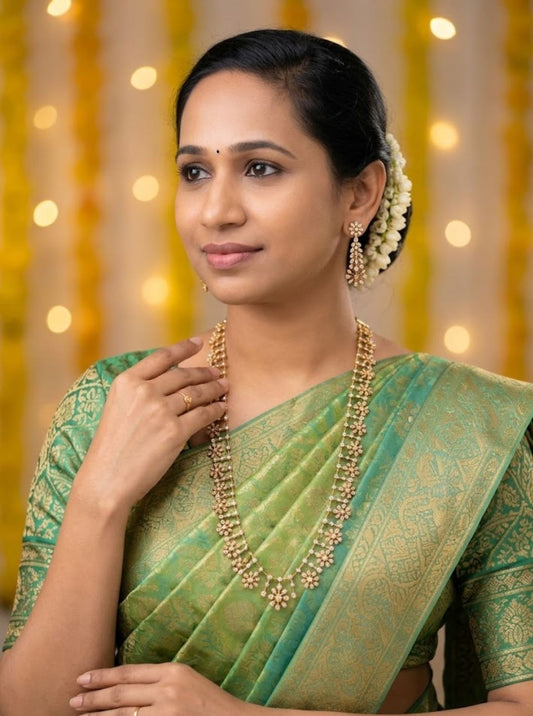 Delicate floral necklace set with sparkling stone flowers and matching long floral earrings.