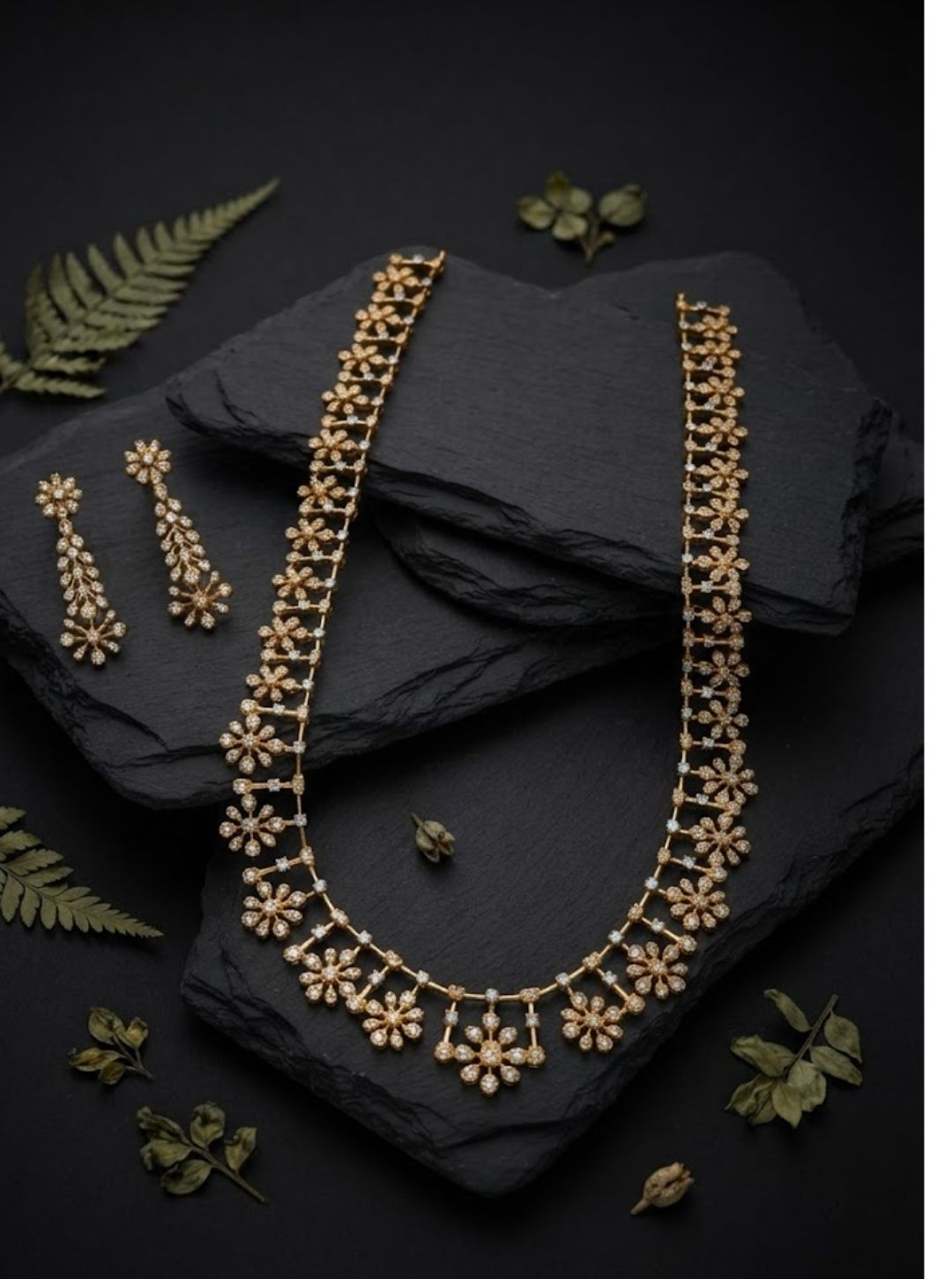 Elegant South Indian necklace featuring repeated flower motifs on a fine gold-toned chain.