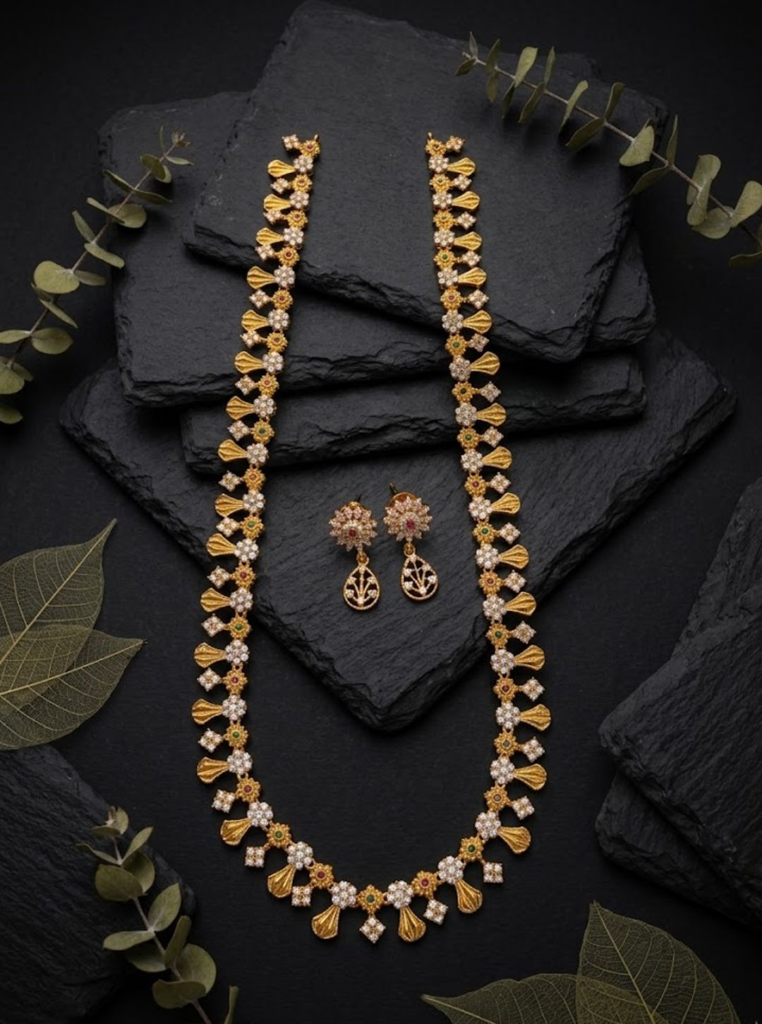 Traditional gold necklace set with intricate floral detailing, gemstone accents and a delicate adjustable cord.