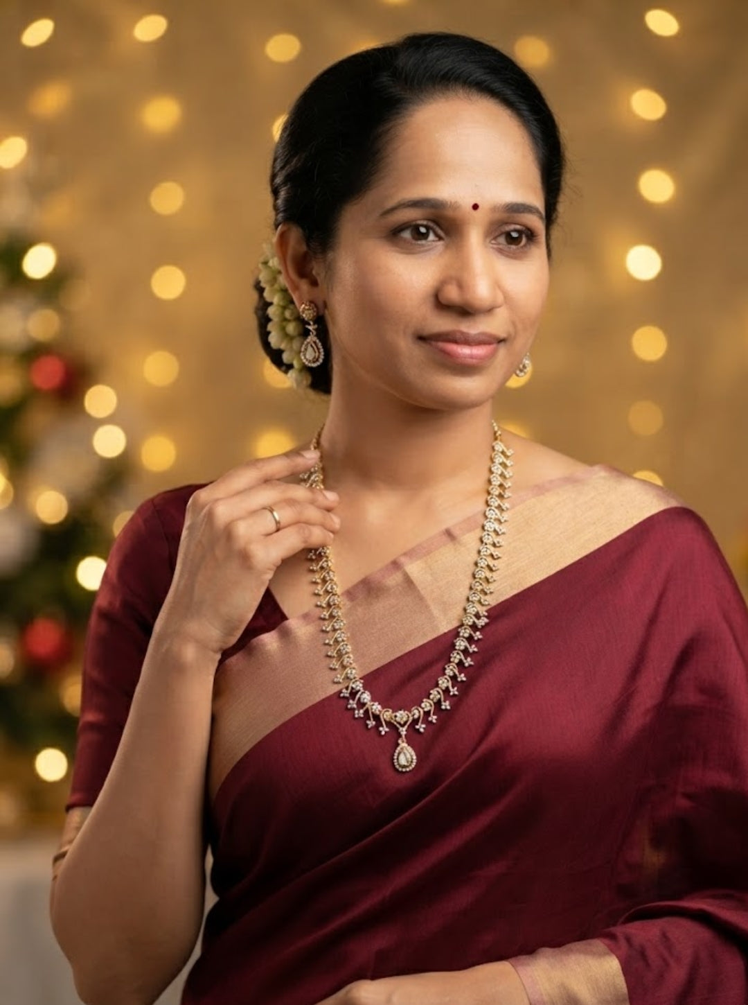 Elegant diamond-style necklace with repeated floral motifs and a teardrop pendant on black slate.