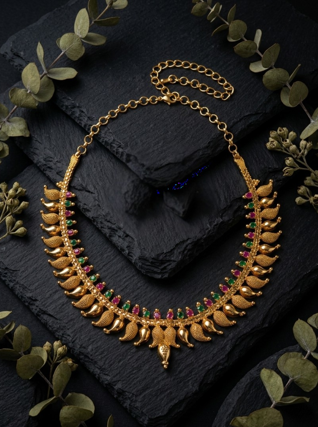 Antique gold temple jewelry with paisley motifs